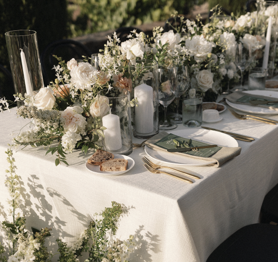 Reception tables set under the olive grove